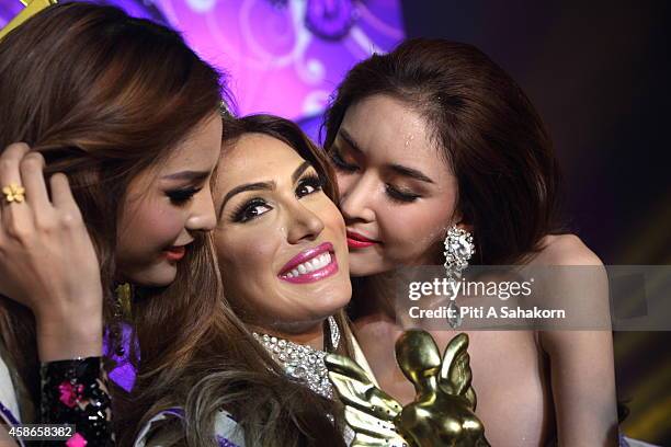 Isabella Santiago of Venezuela is kissed by runner-ups after she was crowned Miss International Queen 2014 at Tiffany's Show theatre in Pattaya city....