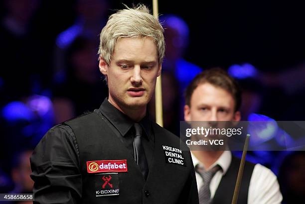 Neil Robertson of Australia reacts against Judd Trump of England on day five of the 2014 Dafabet Champion of Champions at The Ricoh Arena on November...