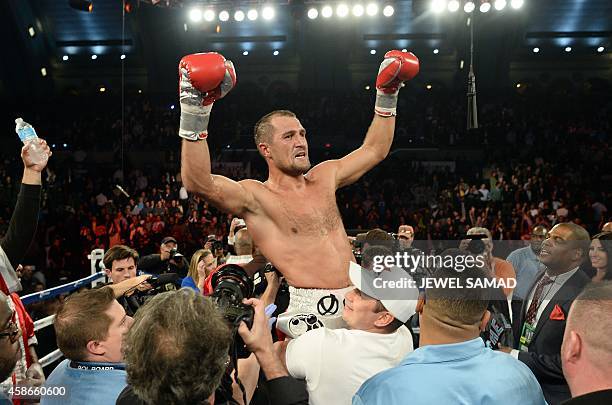 Sergey Kovalev of Russia celebrates defeating Bernard Hopkins of the US fights during their IBF, WBA and WBO light heavyweight title bout at the...