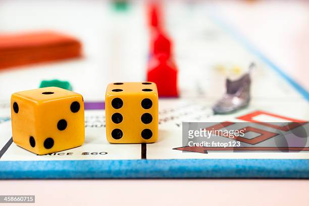go on a monopoly board with shoe and dice - go board game stock pictures, royalty-free photos & images