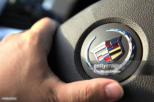 driving a cadillac - vehicle brand names stock pictures, royalty-free photos & images