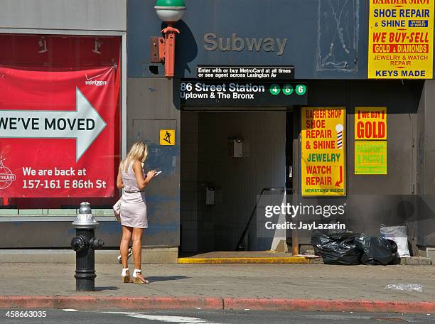 blond woman with tablet computer near subway entrance, nyc - curb stock pictures, royalty-free photos & images