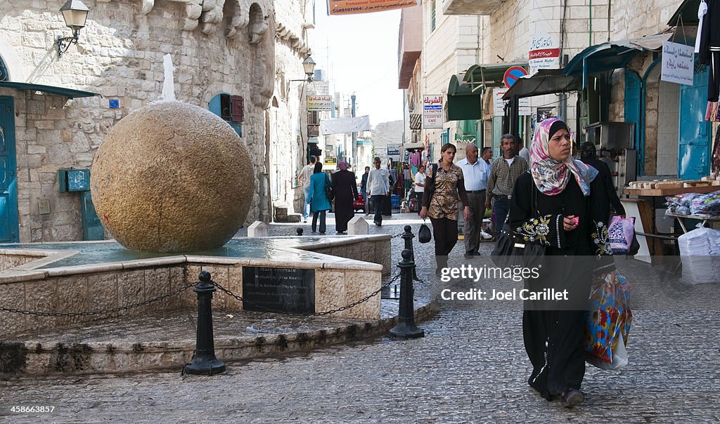 Palestinian woman walking in the West Bank city of Bethlehem