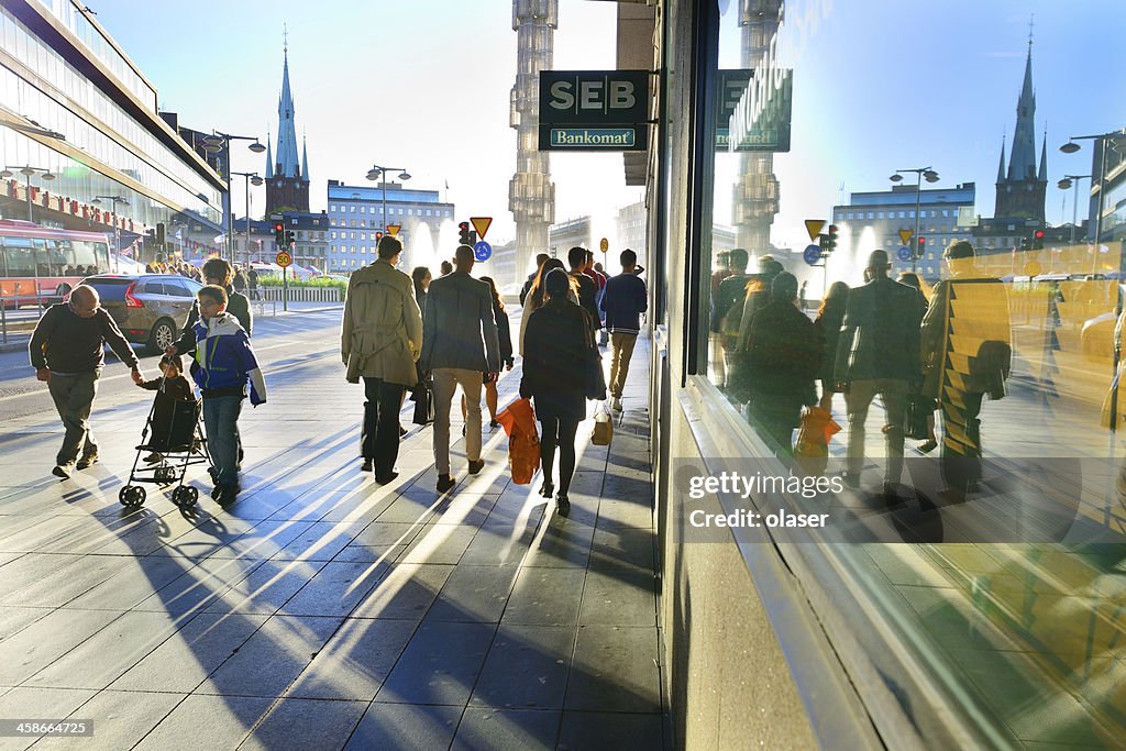 People on sidewalk in sunset