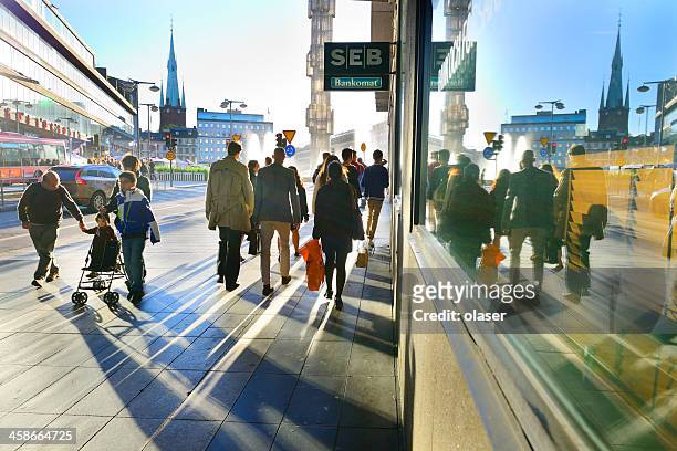 people on sidewalk in sunset - stockholm stock pictures, royalty-free photos & images