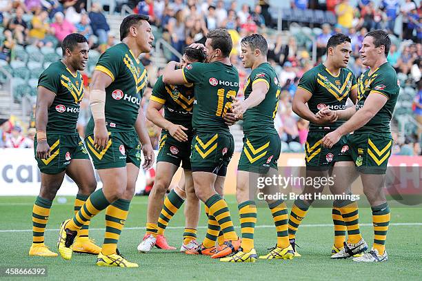 Josh Mansour of Australia celebrates scoring a try with team mates during the Four Nations match between the Australian Kangaroos and Samoa at WIN...