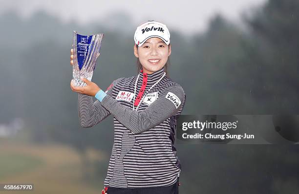 Mi-Hyang Lee of South Korea lifts the winners trophy during a ceremony following the Mizuno Classic at Kintetsu Kashikojima Country Club on November...