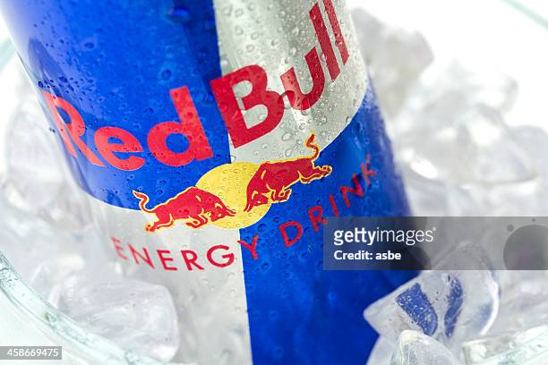 red bull bottle in ice - red bull drink stock pictures, royalty-free photos & images