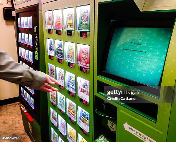 choosing tickets from a lottery vending machine - scratch card stock pictures, royalty-free photos & images