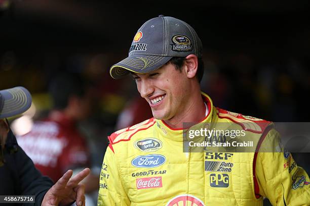 Joey Logano, driver of the Shell-Pennzoil Ford, stands in the garage area during qualifying for the NASCAR Sprint Cup Series Goody's Headache Relief...
