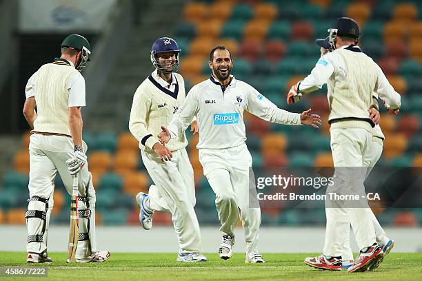 Fawad Ahmed of Victoria celebrates after claiming the wicket of Hamish Kingston of Tasmania during day two of the Sheffield Shield match between...