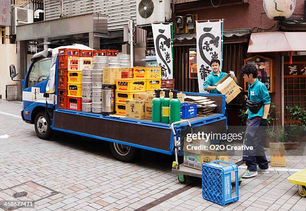 beer deliveryman in japan - unloading stock pictures, royalty-free photos & images