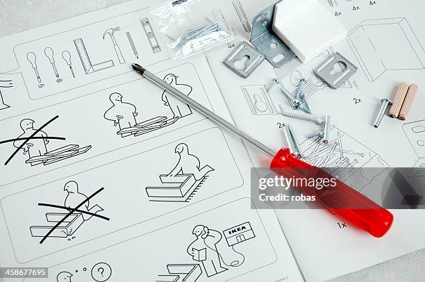 ikea instruction manual with screwdriver and screws - ikea furniture stock pictures, royalty-free photos & images