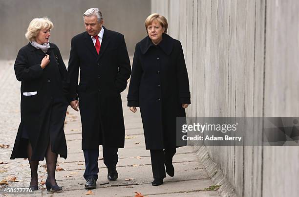 Federal Government Commissioner for Culture and the Media Monika Gruetters, Berlin Mayor Klaus Wowereit and German Chancellor Angela Merkel walk...