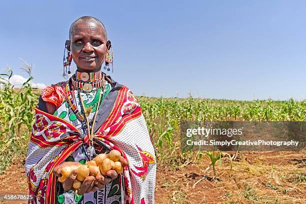 maasai woman holding potatoes - food editorial stock pictures, royalty-free photos & images