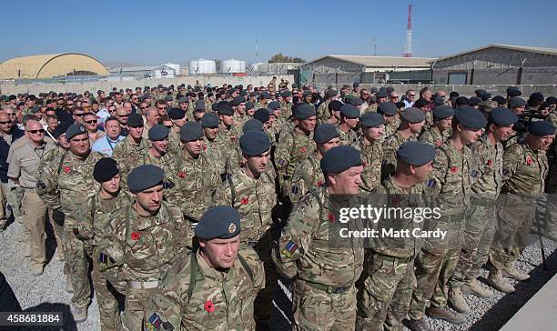 Remembrance poppies adorn uniforms as British troops and service personal remaining in Afghanistan are joined by International Security Assistance...