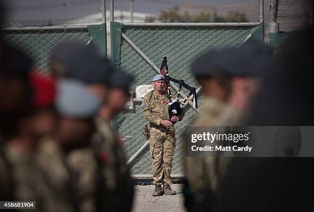 Piper plays as British troops and service personal remaining in Afghanistan are joined by International Security Assistance Force personnel and...