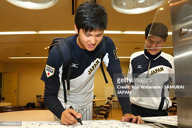 Pitcher Shohei Otani of Samurai Japan signs autographs during a training session at Fukuoka Yahuoku! Dome on November 9, 2014 in Fukuoka, Japan.