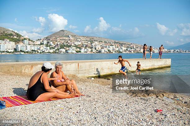 people at beach on albanian coast in sarande - sarande albania stock pictures, royalty-free photos & images