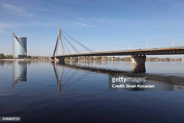 swedbank building and vansu bridge construction over daugava river - riga stock pictures, royalty-free photos & images