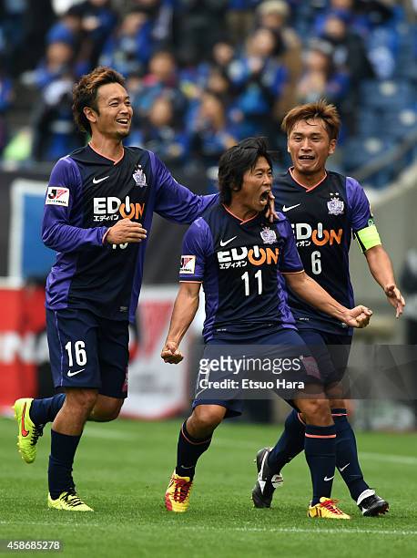 Hisato Sato of Sanfrecce Hiroshima celebrates scoring his team's second goal with his teammates Satoru Yamagishi and Toshihiro Aoyama during the...