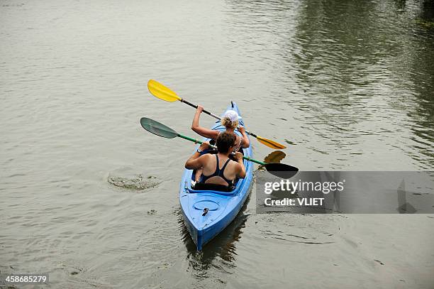 two women canoeing on the river kromme rijn - canoeing stock pictures, royalty-free photos & images