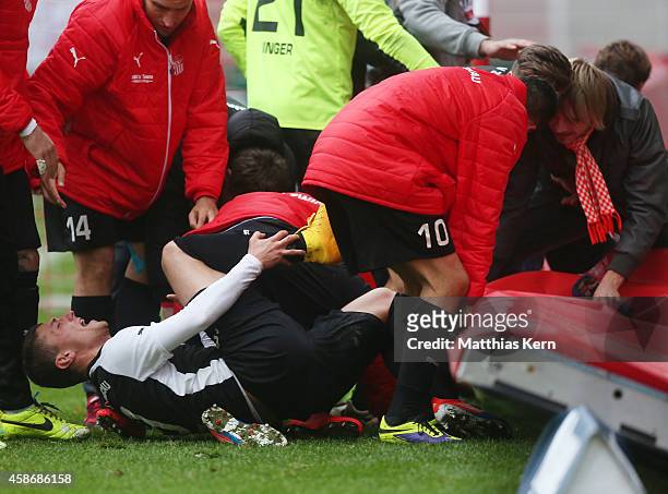 Patrick Grandner of Zwickau is injured after team mates celebrate with their supporters after the Regionalliga Nordost match between 1.FC Union...