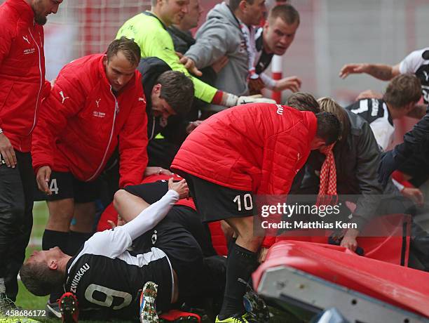 Patrick Grandner of Zwickau is injured after team mates celebrate with their supporters after the Regionalliga Nordost match between 1.FC Union...
