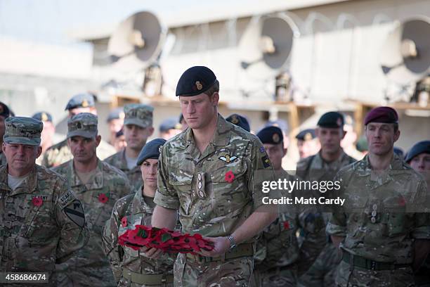 Prince Harry lays a poppy wreath as he joins British troops and service personal remaining in Afghanistan and International Security Assistance Force...