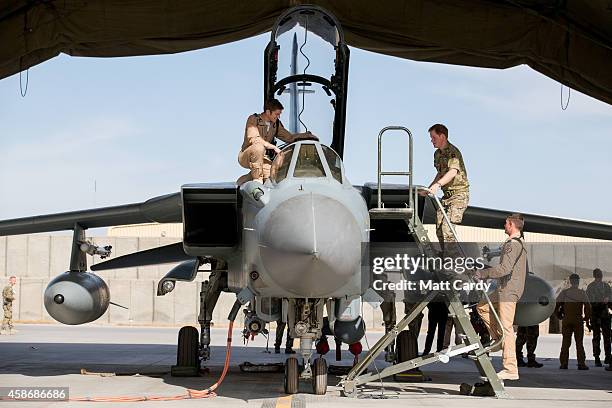 Prince Harry climbs into the cockpit of RAF Tornado following a Remembrance Sunday service at Kandahar Airfield November 9, 2014 in Kandahar,...