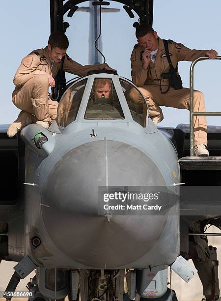 Prince Harry climbs to meet pilots of a RAF Tornado following a Remembrance Sunday service at Kandahar Airfield November 9, 2014 in Kandahar,...