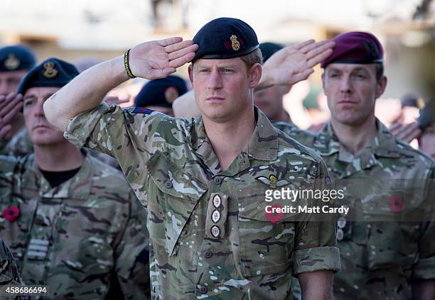 Prince Harry salutes as the Last Post is played as he joins British troops and service personal remaining in Afghanistan and also International...