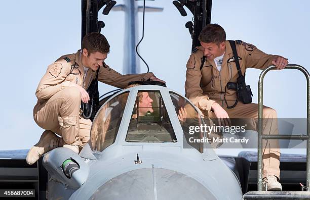 Prince Harry climbs into the cockpit of RAF Tornado following a Remembrance Sunday service at Kandahar Airfield November 9, 2014 in Kandahar,...