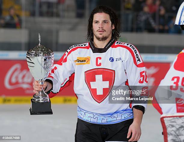 Dino Wieser of Team Switzerland with the cup during the game between Slowakei and Switzerland on November 9, 2014 in Munich, Germany.