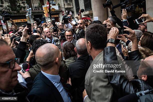 President of Catalonia Artur Mas leaves a polling station surrounded by members of the media and supporters after casting his ballot on November 9,...