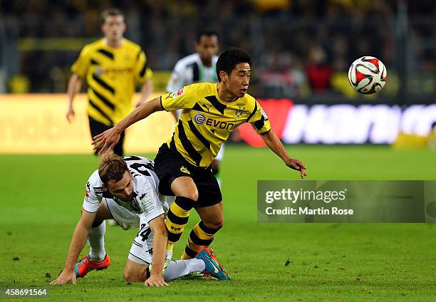 Shinji Kagawa of Dortmund and Tony Jantschke of Gladbach battles for the ball during the Bundesliga match between Borussia Dortmund and Borussia...