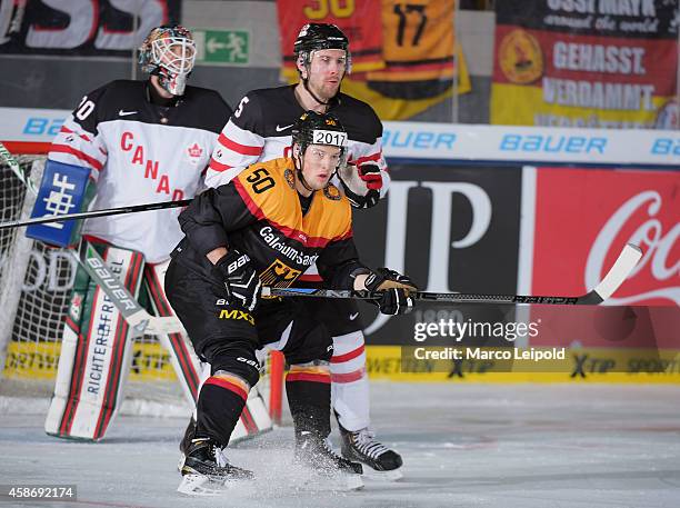 Patrick Hager of Team Germany and Brett Festerling of Team Canada during the game between Canada and Germany on November 9, 2014 in Munich, Germany.