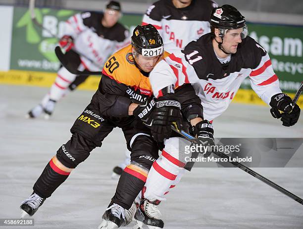 Patrick Hager of Team Germany and Bud Holloway of Team Canada duel during the game between Canada and Germany on November 9, 2014 in Munich, Germany.