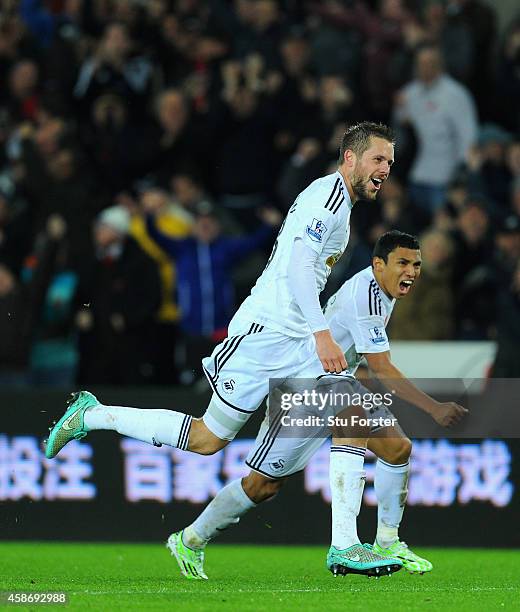 Swansea players Gylfi Sigurdsson and Jefferson Montero celebrate the first Swansea goal during the Barclays Premier League match between Swansea City...