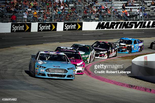 David Ragan, driver of the Wendell Scott Hall of Fame Tribute Ford, leads a pack of cars during the NASCAR Sprint Cup Series Goody's Headache Relief...
