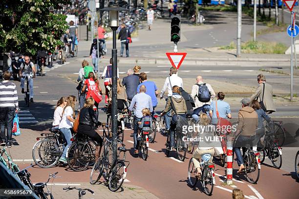 cyclists crossing street in utrecht - utrecht stock pictures, royalty-free photos & images