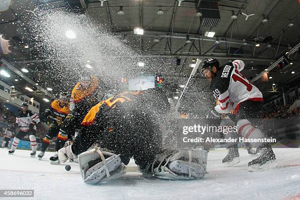 Timo Pielmeier, goalie of Germany in action with Liam Reddox of Canada during match 6 of the Deutschland Cup 2014 between Canada and Germany at...