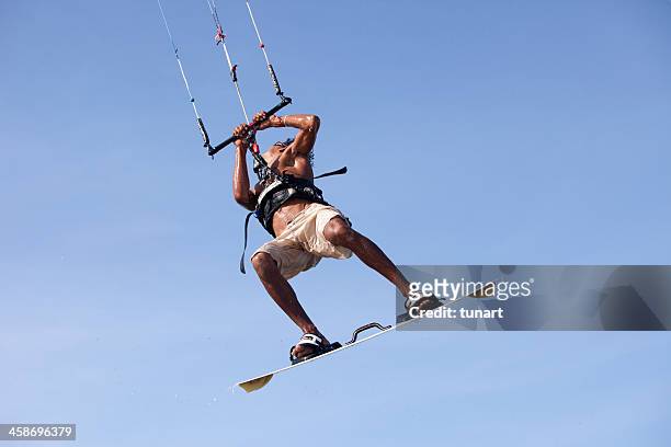 young man kite surfing in a lagoon of jericoacoara, brazil - kite lagoon stock pictures, royalty-free photos & images