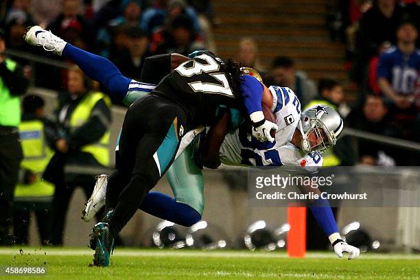 Jason Witten of the Dallas Cowboys is tackled by Johnathan Cyprien of the Jacksonville Jaguars during the NFL week 10 match between the Jackson...