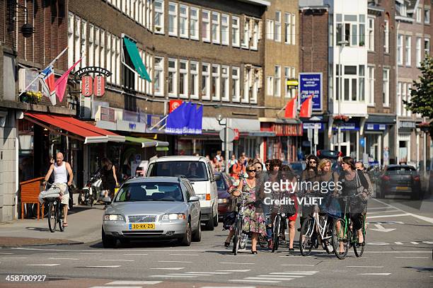 cyclists and cars waiting for the light to turn green - utrecht stock pictures, royalty-free photos & images