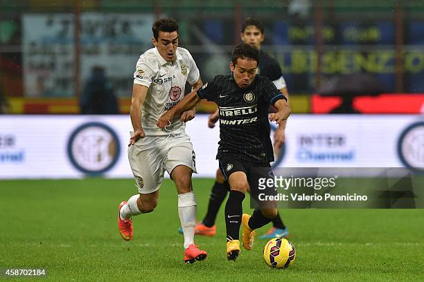 Yuto Nagatomo of FC Internazionale Milano is challenged by Lazaros Christodoulopoulos of Hellas Verona FC during the Serie A match between FC...