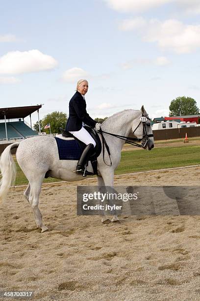 octogenarian on a dressage ahorse - riding habit stock pictures, royalty-free photos & images