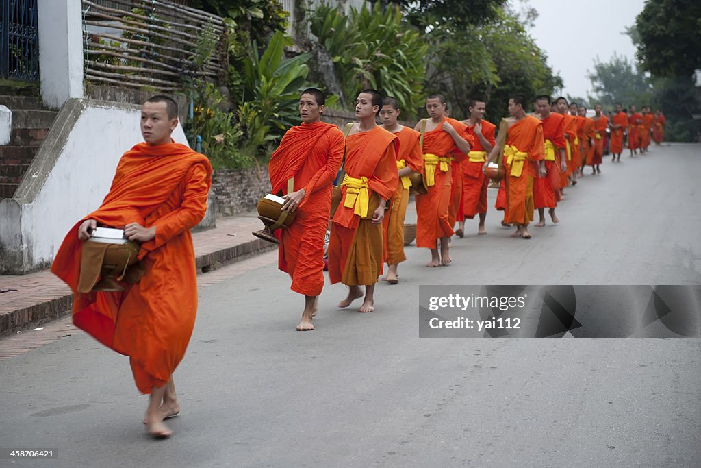 Monks walking on a street