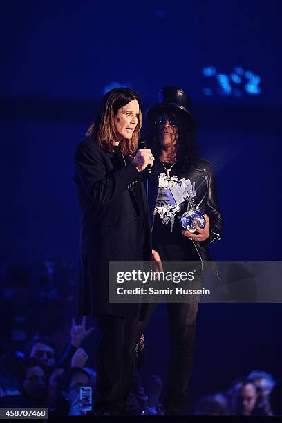 Slash presents Ozzy Osbourne with the Global Icon Award on stage during the MTV EMA's 2014 at The Hydro on November 9, 2014 in Glasgow, Scotland.