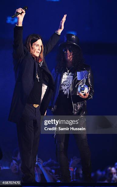 Slash presents Ozzy Osbourne with the Global Icon Award on stage during the MTV EMA's 2014 at The Hydro on November 9, 2014 in Glasgow, Scotland.
